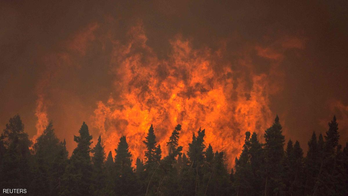 Flames from a wildfire approach trees on the edge of the airport in La Ronge, Saskatchewan July 5, 2015 in a picture provided by Saskatchewan Ministry of Environment contract pilot Corey Hardcastle. The Canadian military has been called in to help fight wildfires in the Western province of Saskatchewan, where 112 active fires have forced the evacuation of more than 13,000 people and threatened several remote towns on Monday. Picture taken July 5, 2015.  REUTERS/Corey Hardcastle/Handout via Reuters  FOR EDITORIAL USE ONLY. NOT FOR SALE FOR MARKETING OR ADVERTISING CAMPAIGNS. THIS IMAGE HAS BEEN SUPPLIED BY A THIRD PARTY. IT IS DISTRIBUTED AS A SERVICE TO CLIENTS