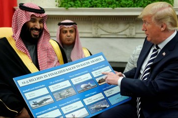 U.S. President Donald Trump holds a chart of military hardware sales as he welcomes Saudi Arabia's Crown Prince Mohammed bin Salman in the Oval Office at the White House in Washington, U.S., March 20, 2018.  REUTERS/Jonathan Ernst